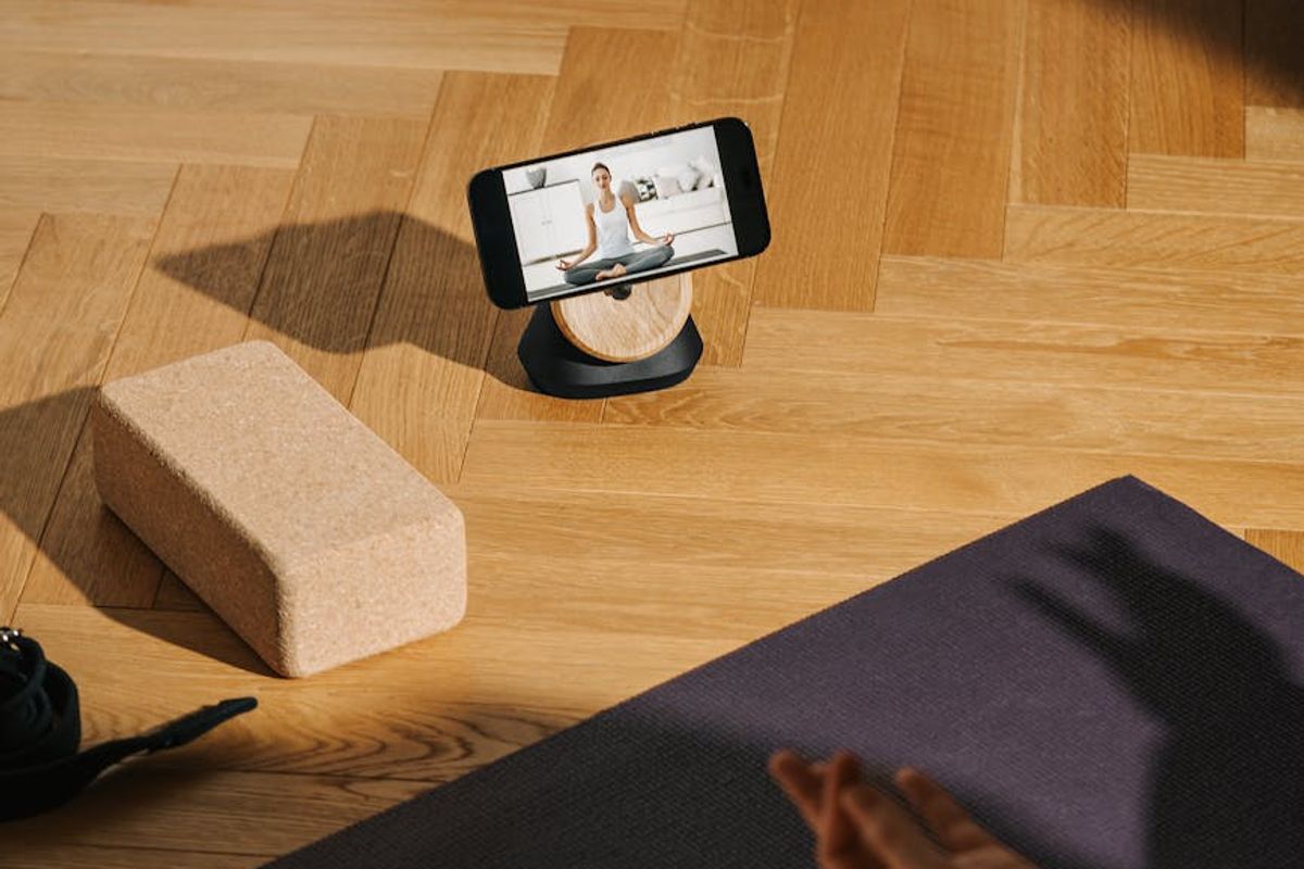 Detailed view of a yoga mat and blocks on a wooden floor